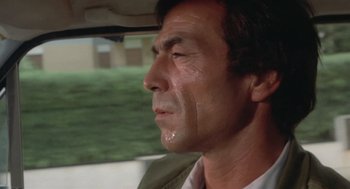 Movie still from “Rabid Dogs” (1974), directed by Mario Bava – A person in a car looking out of the window; Close Up shot, Low angle