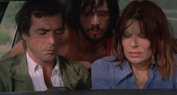 Movie still from “Rabid Dogs” (1974), directed by Mario Bava – A group of people sitting next to each other on a couch; Close Up shot, High angle