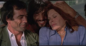 Movie still from “Rabid Dogs” (1974), directed by Mario Bava – A woman is laying on the ground next to two other men; Close Up shot, High angle