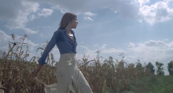 Movie still from “Rabid Dogs” (1974), directed by Mario Bava – A woman walking through a field of corn; Wide shot, Low angle