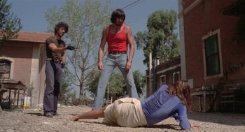 Movie still from “Rabid Dogs” (1974), directed by Mario Bava – A group of people standing on top of the ground; Wide shot, Low angle