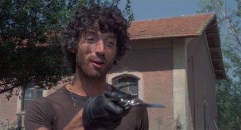 Movie still from “Rabid Dogs” (1974), directed by Mario Bava – A man holding a pair of scissors in his hand; Close Up shot, Low angle