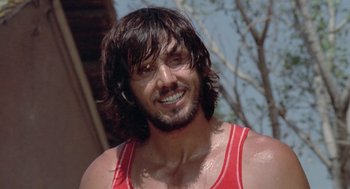 Movie still from “Rabid Dogs” (1974), directed by Mario Bava – A person wearing a tank top; Close Up shot, Low angle