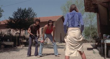 Movie still from “Rabid Dogs” (1974), directed by Mario Bava – Two men and a woman are playing a game of frisbee; Wide shot, Low angle