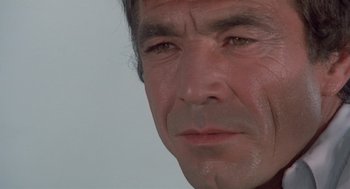 Movie still from “Rabid Dogs” (1974), directed by Mario Bava – A man's face with a lot of dirt on his face; Extreme Close Up shot, Low angle