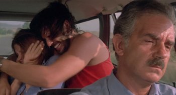 Movie still from “Rabid Dogs” (1974), directed by Mario Bava – A man and a woman in the back seat of a car; Close Up shot, Over the shoulder angle