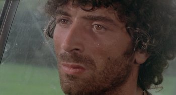 Movie still from “Rabid Dogs” (1974), directed by Mario Bava – A person with a beard; Close Up shot, Low angle