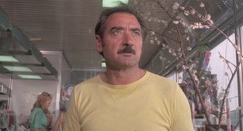 Movie still from “Rabid Dogs” (1974), directed by Mario Bava – A person wearing a yellow t - shirt; Close Up shot, Low angle