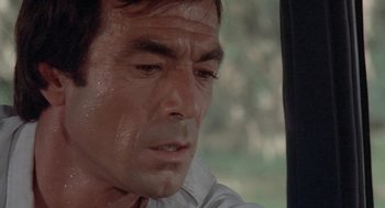 Movie still from “Rabid Dogs” (1974), directed by Mario Bava – A man's face as he looks out a window; Close Up shot, High angle