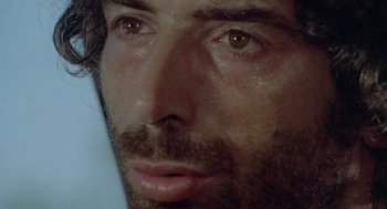 Movie still from “Rabid Dogs” (1974), directed by Mario Bava – A man's face with water on his face; Extreme Close Up shot, Low angle