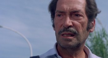 Movie still from “Rabid Dogs” (1974), directed by Mario Bava – An older man with a beard and a mustache; Close Up shot, Low angle