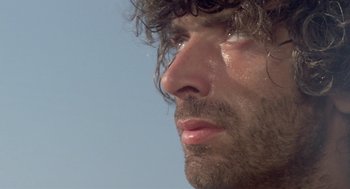 Movie still from “Rabid Dogs” (1974), directed by Mario Bava – A person's face with water droplets on his face; Close Up shot, Low angle