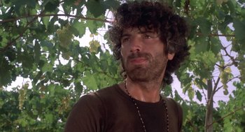 Movie still from “Rabid Dogs” (1974), directed by Mario Bava – A person wearing a necklace; Close Up shot, Low angle