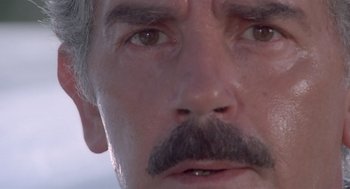 Movie still from “Rabid Dogs” (1974), directed by Mario Bava – A man's face with a mustache; Extreme Close Up shot, Low angle