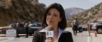 Movie still from “Race to Witch Mountain” (2009), directed by Andy Fickman – A woman is holding a microphone while standing on the side of the road; Close Up shot, Low angle