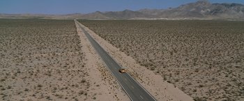 Movie still from “Race to Witch Mountain” (2009), directed by Andy Fickman – An aerial view of an empty road in the middle of the desert; Extreme Wide shot, High angle