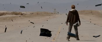 Movie still from “Race to Witch Mountain” (2009), directed by Andy Fickman – A man walking down the street with a skateboard; Wide shot, Low angle