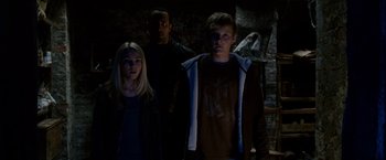 Movie still from “Race to Witch Mountain” (2009), directed by Andy Fickman – A group of people standing next to each other in the dark; Medium shot, Low angle