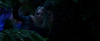 Movie still from “Race to Witch Mountain” (2009), directed by Andy Fickman – A woman standing in the woods at night; Medium shot, Over the shoulder angle