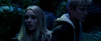 Movie still from “Race to Witch Mountain” (2009), directed by Andy Fickman – A woman and a man are sitting next to each other in the dark; Close Up shot, Over the shoulder angle
