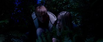 Movie still from “Race to Witch Mountain” (2009), directed by Andy Fickman – A man and a woman sitting next to each other in the dark; Medium shot, Low angle