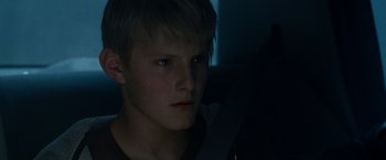 Movie still from “Race to Witch Mountain” (2009), directed by Andy Fickman – A young man is sitting in a car seat at night; Close Up shot, Over the shoulder angle