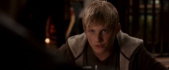 Movie still from “Race to Witch Mountain” (2009), directed by Andy Fickman – A young man with blonde hair and blue eyes stares into the camera; Close Up shot, Over the shoulder angle