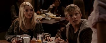 Movie still from “Race to Witch Mountain” (2009), directed by Andy Fickman – A man and a woman sitting at a table with food; Medium shot, Over the shoulder angle