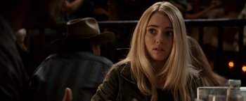 Movie still from “Race to Witch Mountain” (2009), directed by Andy Fickman – A woman with long blonde hair sitting in front of a crowd; Close Up shot, Over the shoulder angle