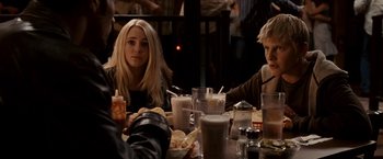 Movie still from “Race to Witch Mountain” (2009), directed by Andy Fickman – Two people sitting at a table with drinks and food; Medium shot, Over the shoulder angle