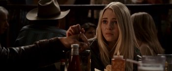 Movie still from “Race to Witch Mountain” (2009), directed by Andy Fickman – A woman sitting at a table with a bottle of beer; Close Up shot, Over the shoulder angle