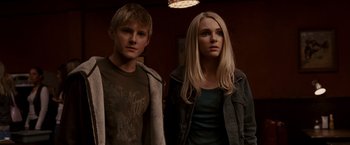 Movie still from “Race to Witch Mountain” (2009), directed by Andy Fickman – A man and a woman standing next to each other in a room; Medium shot, Low angle