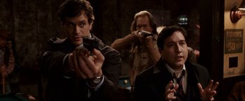 Movie still from “Race to Witch Mountain” (2009), directed by Andy Fickman – A group of men in suits and ties holding guns; Medium shot, Over the shoulder angle