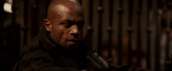 Movie still from “Race to Witch Mountain” (2009), directed by Andy Fickman – A man in a black jacket holding a gun in his hand; Close Up shot, Low angle
