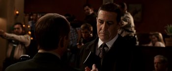 Movie still from “Race to Witch Mountain” (2009), directed by Andy Fickman – A man in a suit and tie holding a cell phone; Close Up shot, Over the shoulder angle