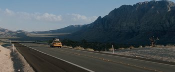 Movie still from “Race to Witch Mountain” (2009), directed by Andy Fickman – A car driving down a road with mountains in the background; Extreme Wide shot, Over the shoulder angle
