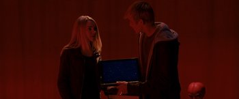Movie still from “Race to Witch Mountain” (2009), directed by Andy Fickman – A man and a woman looking at a laptop; Medium shot, Over the shoulder angle