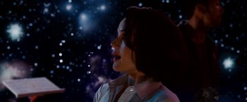 Movie still from “Race to Witch Mountain” (2009), directed by Andy Fickman – A woman is standing in front of a star filled sky; Medium shot, Low angle