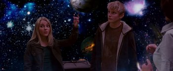 Movie still from “Race to Witch Mountain” (2009), directed by Andy Fickman – A boy and a girl in front of a space background; Medium shot, Low angle