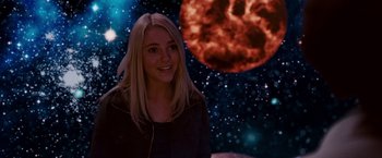 Movie still from “Race to Witch Mountain” (2009), directed by Andy Fickman – A woman standing in front of a space background; Medium shot, Over the shoulder angle