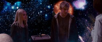 Movie still from “Race to Witch Mountain” (2009), directed by Andy Fickman – A young man standing in front of a space background; Medium shot, Over the shoulder angle