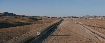 Movie still from “Race to Witch Mountain” (2009), directed by Andy Fickman – An rv driving down a road in the middle of the desert; Extreme Wide shot, High angle