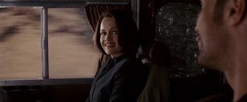 Movie still from “Race to Witch Mountain” (2009), directed by Andy Fickman – A woman sitting in a chair on a train; Close Up shot, Over the shoulder angle