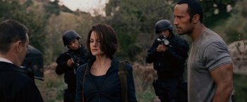 Movie still from “Race to Witch Mountain” (2009), directed by Andy Fickman – A group of people standing next to each other on a field; Medium shot, Over the shoulder angle