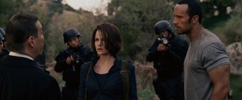 Movie still from “Race to Witch Mountain” (2009), directed by Andy Fickman – A group of people standing next to each other on top of a field; Medium shot, Over the shoulder angle