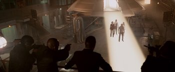 Movie still from “Race to Witch Mountain” (2009), directed by Andy Fickman – Two men in suits are standing in front of a projection screen; Extreme Wide shot, High angle