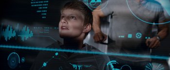 Movie still from “Race to Witch Mountain” (2009), directed by Andy Fickman – A young boy is looking up at a computer screen; Close Up shot, Overhead angle