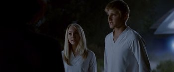 Movie still from “Race to Witch Mountain” (2009), directed by Andy Fickman – Two young people standing next to each other in front of a tree; Medium shot, Over the shoulder angle