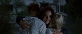 Movie still from “Race to Witch Mountain” (2009), directed by Andy Fickman – A group of people hugging each other in the dark; Close Up shot, Over the shoulder angle