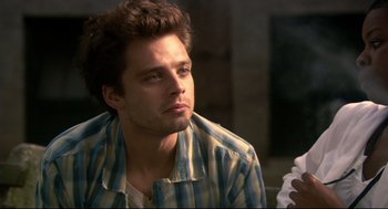 Movie still from “Rachel Getting Married” (2008), directed by Jonathan Demme – A man with a beard is sitting in a room; Close Up shot, Over the shoulder angle